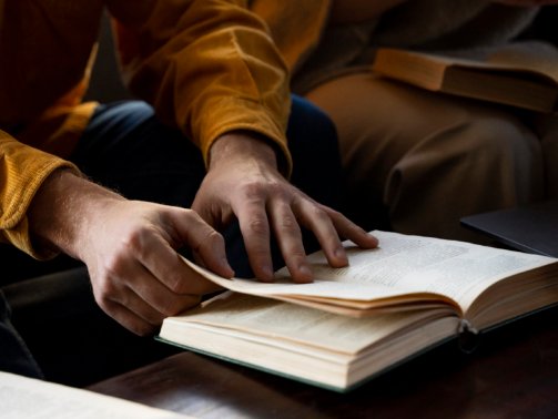 high-angle-hands-holding-book