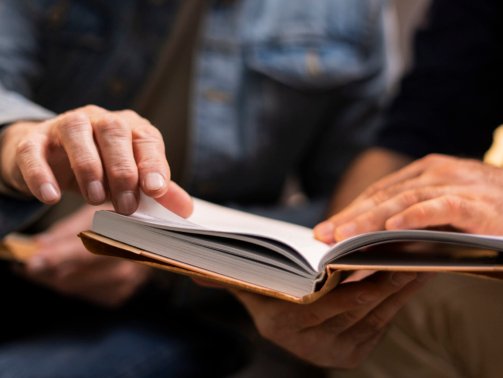 men-reading-together-front-view